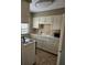 Functional kitchen with white cabinets, tile backsplash, appliances, and lots of countertop space at 1920 E Edgewood Dr # T6, Lakeland, FL 33803