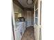 Kitchen featuring white cabinets, appliances, tile backsplash, and access door at 1920 E Edgewood Dr # T6, Lakeland, FL 33803