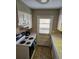 Kitchen features white appliances, cabinets, and access door for a functional and well-lit space at 1920 E Edgewood Dr # T6, Lakeland, FL 33803