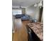Spacious living room with neutral walls, hardwood floors and a gray couch set at 1920 E Edgewood Dr # T6, Lakeland, FL 33803