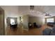 Open floorplan with neutral paint, wood flooring and a gray sofa set at 1920 E Edgewood Dr # T6, Lakeland, FL 33803