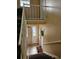 Carpeted stairwell with white railings and a view of the entryway with a floral wreath at 1920 E Edgewood Dr # T6, Lakeland, FL 33803