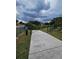 Picturesque walkway leading to a serene pond, enhanced with natural landscaping at 1920 E Edgewood Dr # T6, Lakeland, FL 33803