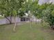 The property has a generous backyard with a lush lawn, mature trees, and a screened-in porch at 2033 Normandy Heights Dr, Winter Haven, FL 33880