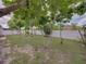 Well-maintained backyard featuring a lush lawn, mature trees, and a cozy seating area at 2033 Normandy Heights Dr, Winter Haven, FL 33880
