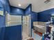 Bathroom features a shower, bathtub, and blue textured walls at 2033 Normandy Heights Dr, Winter Haven, FL 33880