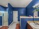 Bathroom with a shower, bathtub, and dual vanity with blue textured walls at 2033 Normandy Heights Dr, Winter Haven, FL 33880