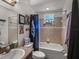 Bathroom with vanity and shower featuring neutral colored tiles and fixtures at 2033 Normandy Heights Dr, Winter Haven, FL 33880