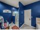 Bathroom featuring a shower, bathtub, blue textured walls, and modern fixtures at 2033 Normandy Heights Dr, Winter Haven, FL 33880