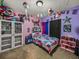 Colorful bedroom featuring unique decor, carpet flooring, and ample storage at 2033 Normandy Heights Dr, Winter Haven, FL 33880