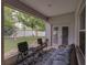The covered patio features furniture and a view into the lush backyard with a white fence at 2033 Normandy Heights Dr, Winter Haven, FL 33880