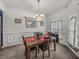 Traditional dining room features a dark wood table, seating for four, and stylish light fixture at 2033 Normandy Heights Dr, Winter Haven, FL 33880