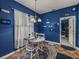 Bright dining area featuring a white table set, window views, and blue accent wall at 2033 Normandy Heights Dr, Winter Haven, FL 33880