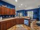 Kitchen showcasing wood cabinets, stainless steel sink, and a view into the dining area at 2033 Normandy Heights Dr, Winter Haven, FL 33880
