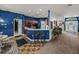 Eat-in kitchen with bar seating features bright light, tile flooring, and seamless flow to other living areas at 2033 Normandy Heights Dr, Winter Haven, FL 33880