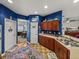 Well-lit kitchen featuring wood cabinetry, stainless steel sink, and views to the dining area at 2033 Normandy Heights Dr, Winter Haven, FL 33880