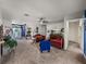 Spacious living room showcasing neutral carpet, a ceiling fan, and seamless flow to the entryway at 2033 Normandy Heights Dr, Winter Haven, FL 33880