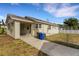 Rear view showcasing the home's layout, including carport, backyard, and well-maintained exterior at 2814 Coventry Ave, Lakeland, FL 33803