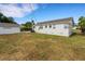 Backyard view showing the home's exterior, lawn, and detached garage, ideal for outdoor enjoyment at 2814 Coventry Ave, Lakeland, FL 33803