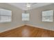 Light-filled bedroom featuring hardwood floors and bright white trim at 2814 Coventry Ave, Lakeland, FL 33803