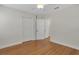 Bedroom with hardwood floors, white trim, and ample closet space at 2814 Coventry Ave, Lakeland, FL 33803