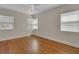 Bedroom featuring hardwood floors, white trim, and bright windows at 2814 Coventry Ave, Lakeland, FL 33803