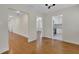Open-concept hallway featuring beautiful hardwood floors, white trim, and access to multiple rooms at 2814 Coventry Ave, Lakeland, FL 33803
