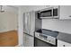 Modern kitchen featuring stainless steel appliances, including refrigerator, microwave, and range at 2814 Coventry Ave, Lakeland, FL 33803