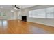 Bright living room with fireplace, built-ins, and gleaming hardwood floors at 2814 Coventry Ave, Lakeland, FL 33803