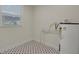 Small utility room featuring patterned tile flooring and essential mechanical equipment at 2814 Coventry Ave, Lakeland, FL 33803