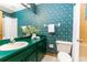 Bathroom with decorative wallpaper, vanity with green countertop, and a shower at 3226 Cherry Hill S Cir, Lakeland, FL 33810