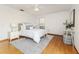 Bedroom with hardwood floors, ceiling fan, and two bedside tables with lamps at 3226 Cherry Hill S Cir, Lakeland, FL 33810
