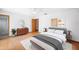 Bright bedroom features wood floors, dresser, modern art, and a serene and restful decor at 3226 Cherry Hill S Cir, Lakeland, FL 33810