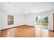 Bright bedroom featuring wood floors, ample natural light, and sliding glass door to backyard at 3226 Cherry Hill S Cir, Lakeland, FL 33810