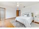 Bright bedroom featuring hardwood floors, ensuite bathroom, and ceiling fan at 3226 Cherry Hill S Cir, Lakeland, FL 33810