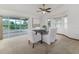 Bright dining room with ceiling fan, carpet floors, and sliding glass doors to an enclosed patio at 3226 Cherry Hill S Cir, Lakeland, FL 33810