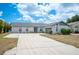 Lovely single-story home with a spacious driveway, well-kept lawn, and beautiful landscaping at 3226 Cherry Hill S Cir, Lakeland, FL 33810