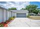 Attached garage with lovely adjacent landscaping and a long driveway at 3226 Cherry Hill S Cir, Lakeland, FL 33810