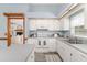 Bright kitchen with white cabinets and stainless steel appliances, open to the living space at 3226 Cherry Hill S Cir, Lakeland, FL 33810