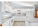 Bright kitchen with white cabinetry, modern appliances, wood-style floors and lots of sunlight at 3226 Cherry Hill S Cir, Lakeland, FL 33810