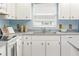 Cozy kitchen featuring white cabinets, gray countertops, and stainless steel appliances at 3226 Cherry Hill S Cir, Lakeland, FL 33810