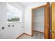 A bright laundry room with wood floors and a large shelved closet for ample storage at 3226 Cherry Hill S Cir, Lakeland, FL 33810