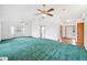Spacious living room with green carpet, ceiling fans, and bay windows at 3226 Cherry Hill S Cir, Lakeland, FL 33810
