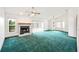 Bright living room with green carpet, fireplace, ceiling fan, and bay windows at 3226 Cherry Hill S Cir, Lakeland, FL 33810
