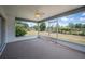 Relaxing enclosed patio offering a view of the spacious, grassy backyard at 3226 Cherry Hill S Cir, Lakeland, FL 33810