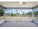 Cozy screened-in patio with views of the backyard on a sunny day at 3226 Cherry Hill S Cir, Lakeland, FL 33810