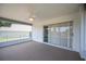 Enclosed patio with ceiling fan and sliding glass doors to the home's interior at 3226 Cherry Hill S Cir, Lakeland, FL 33810