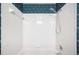 Shower/tub combination with white tile and vintage wallpaper at 3226 Cherry Hill S Cir, Lakeland, FL 33810