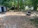 Simple backyard with a bench, storage shed, and scattered debris at 411 Keat Ave, Auburndale, FL 33823