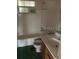 Bathroom with a tub, window, and single sink vanity at 411 Keat Ave, Auburndale, FL 33823